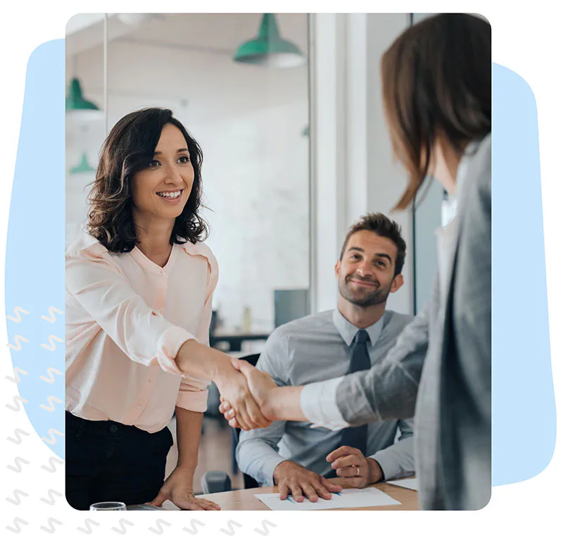 Staffing hiring manager shaking hands with new employee